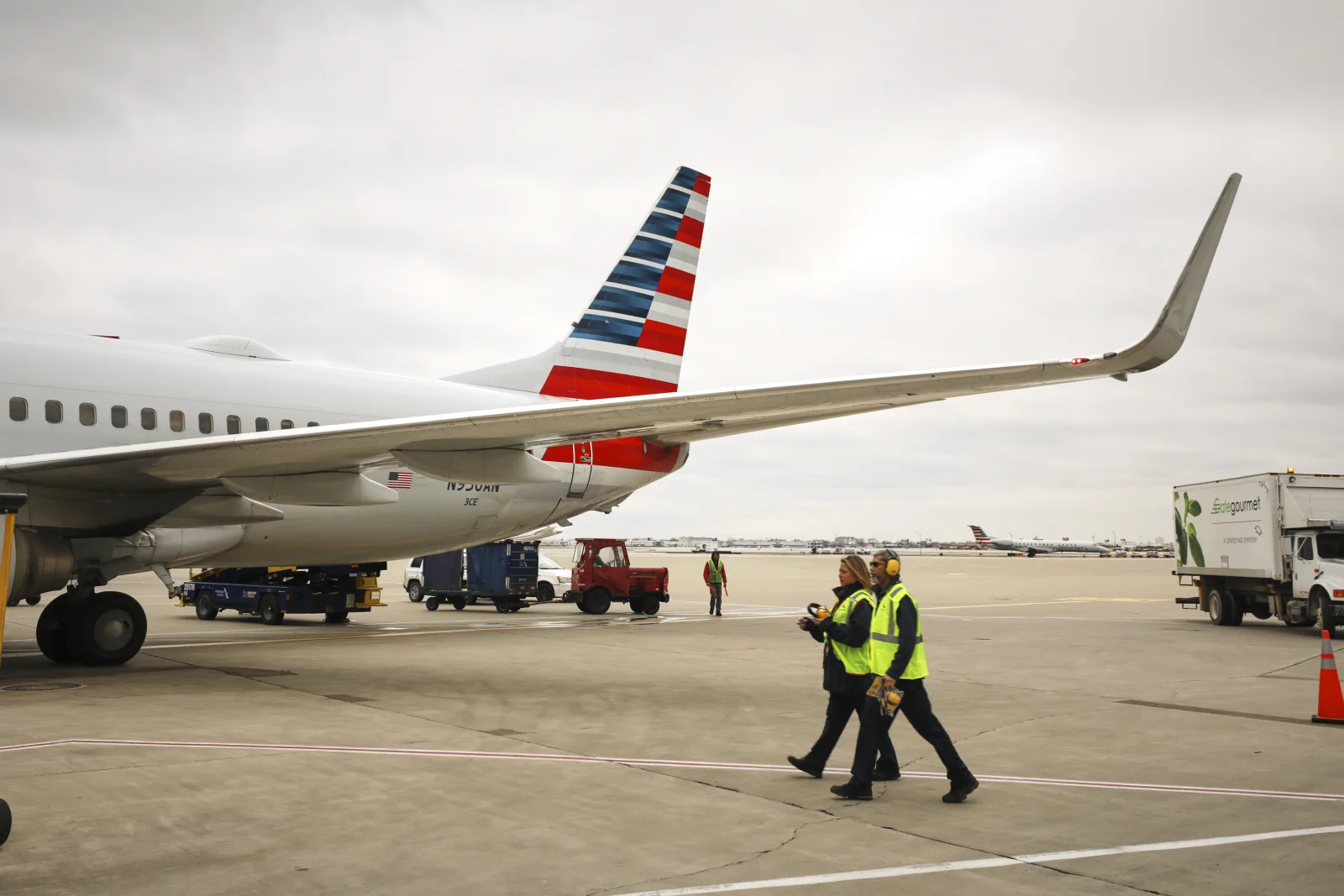 American Airlines widebody on stand, oneworld's North American backbone with Alaska Airlines.