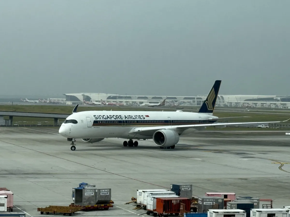 A Singapore Airlines Airbus A350-900 taxiing in side profile, Singapore Airlines titles clearly legible on the fuselage